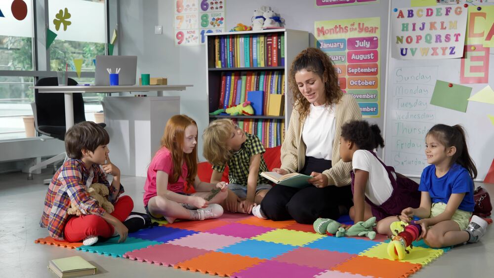 A teacher reading to her students in the classroom